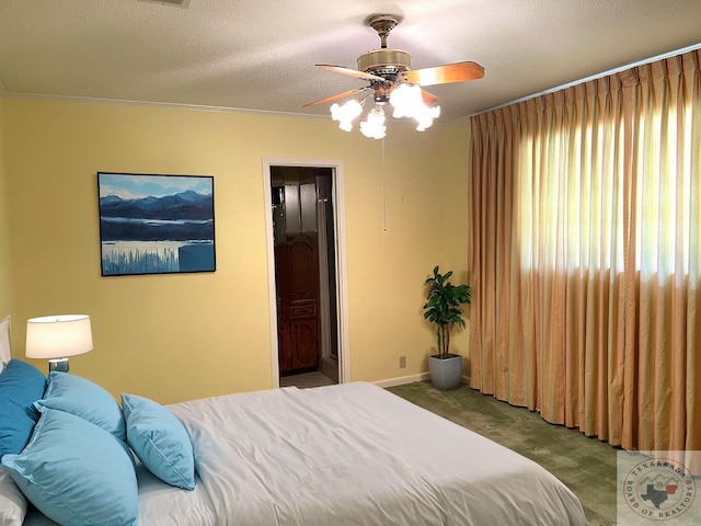 bedroom with ceiling fan, ensuite bathroom, a textured ceiling, carpet floors, and ornamental molding