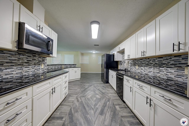 kitchen with baseboards, white cabinets, stainless steel appliances, and decorative backsplash