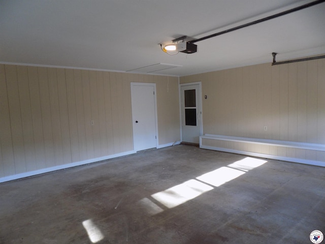 garage featuring wood walls and a garage door opener