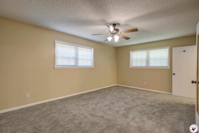 spare room with ceiling fan, a healthy amount of sunlight, baseboards, and carpet floors