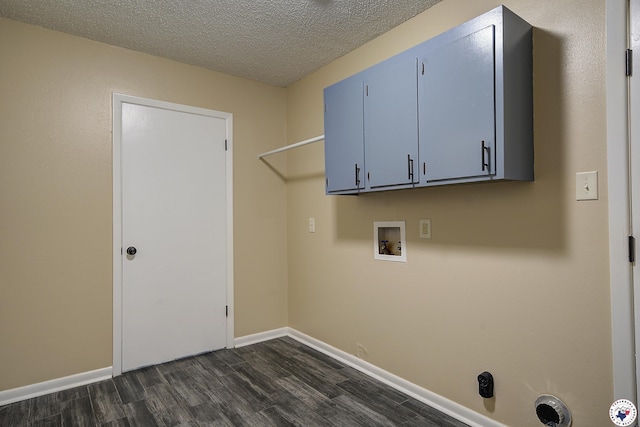 laundry area featuring washer hookup, cabinet space, dark wood-style floors, and a textured ceiling