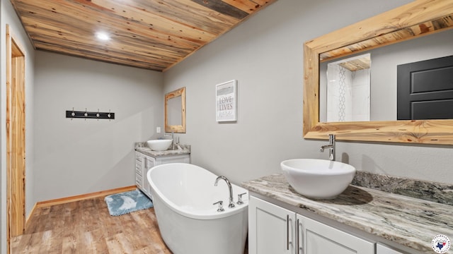 154 Serenity Loop, Glenwood, AR 71943 - full bath with two vanities, a freestanding bath, wood finished floors, baseboards, and wood ceiling
