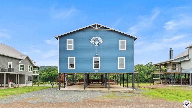 154 Serenity Loop, Glenwood, AR 71943 - rear view of property featuring a carport, driveway, and stairs
