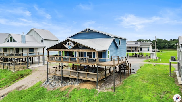 154 Serenity Loop, Glenwood, AR 71943 - back of property featuring a wooden deck and a lawn