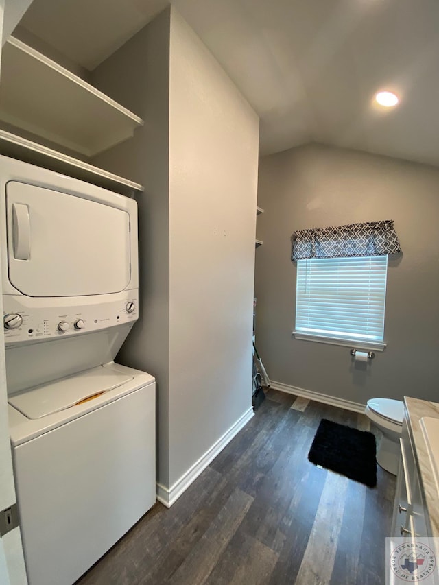 clothes washing area with stacked washing maching and dryer and dark hardwood / wood-style flooring