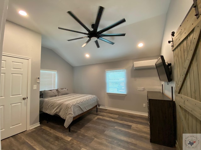 bedroom featuring vaulted ceiling, ceiling fan, dark wood-type flooring, a barn door, and an AC wall unit