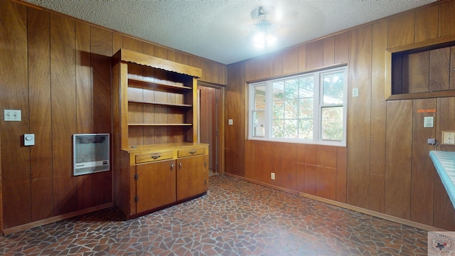 office featuring wood walls and a textured ceiling