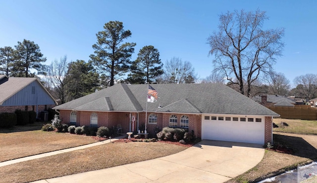 view of front of house with a garage, driveway, brick siding, and a shingled roof