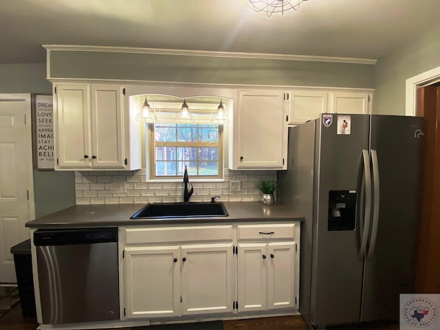 kitchen featuring decorative backsplash, sink, white cabinets, and appliances with stainless steel finishes