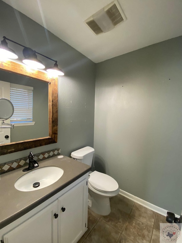 bathroom featuring vanity, toilet, and tile patterned floors