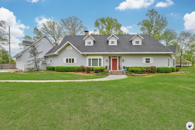 cape cod house featuring a chimney and a front lawn