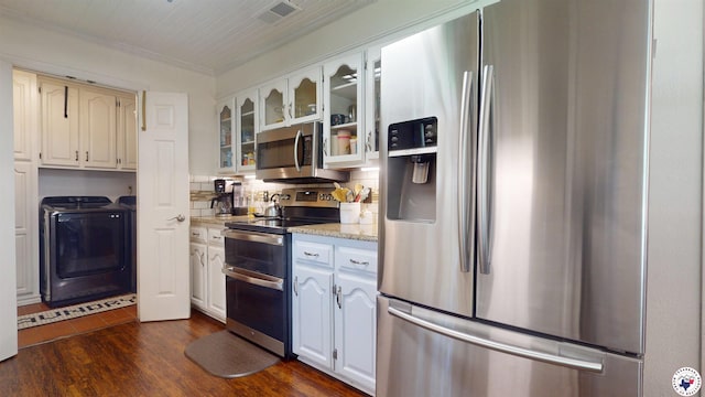 6010 Shadyside Ln, Texarkana, TX 75503 - kitchen featuring stainless steel appliances, glass insert cabinets, independent washer and dryer, dark wood-style flooring, and white cabinets