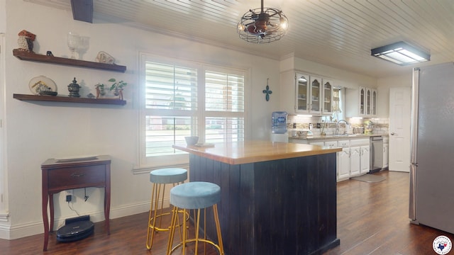 6010 Shadyside Ln, Texarkana, TX 75503 - kitchen featuring stainless steel appliances, light countertops, white cabinetry, glass insert cabinets, and dark wood-style floors