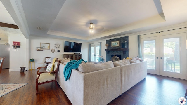 6010 Shadyside Ln, Texarkana, TX 75503 - living area with french doors, a raised ceiling, dark wood-style flooring, ceiling fan, and a fireplace