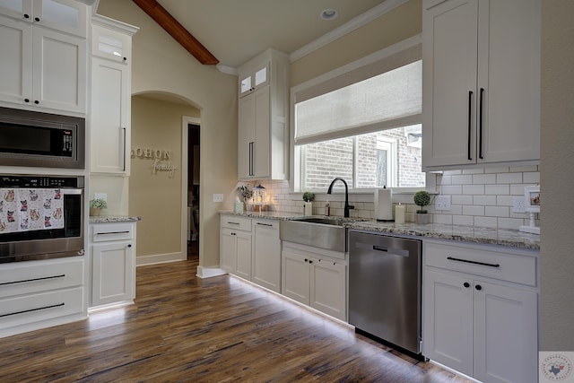 kitchen with white cabinetry, sink, tasteful backsplash, and stainless steel appliances