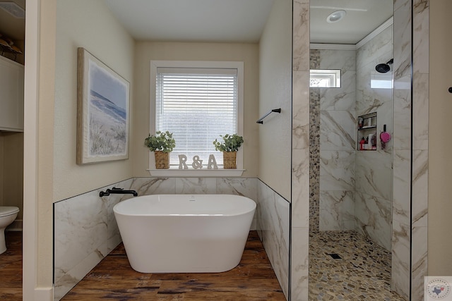 bathroom with independent shower and bath, hardwood / wood-style flooring, tile walls, and toilet