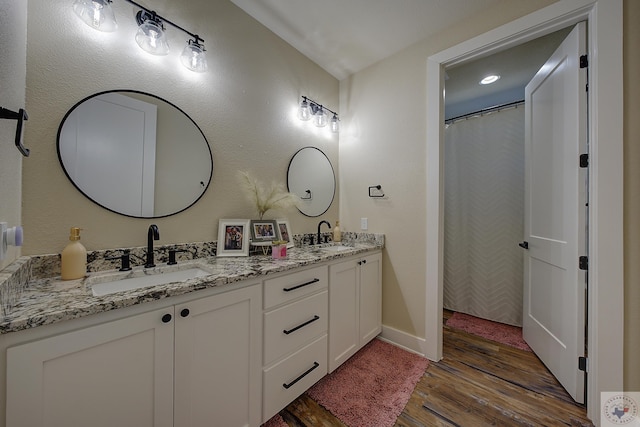 bathroom featuring wood-type flooring and vanity