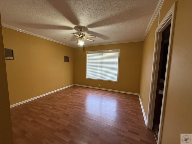 unfurnished room with ceiling fan, a textured ceiling, hardwood / wood-style flooring, and ornamental molding