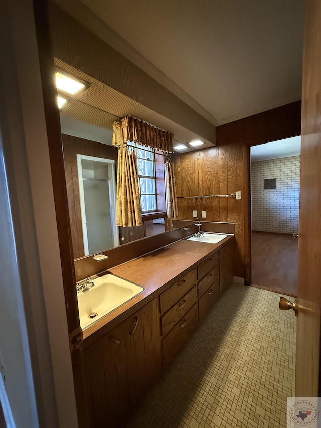 bathroom featuring vanity, wooden walls, and ornamental molding