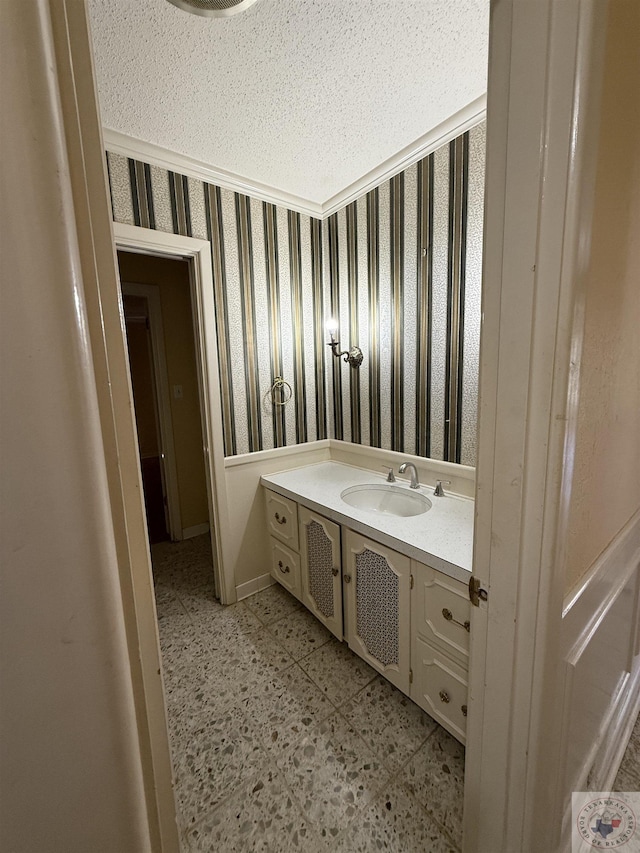 bathroom featuring a textured ceiling and vanity