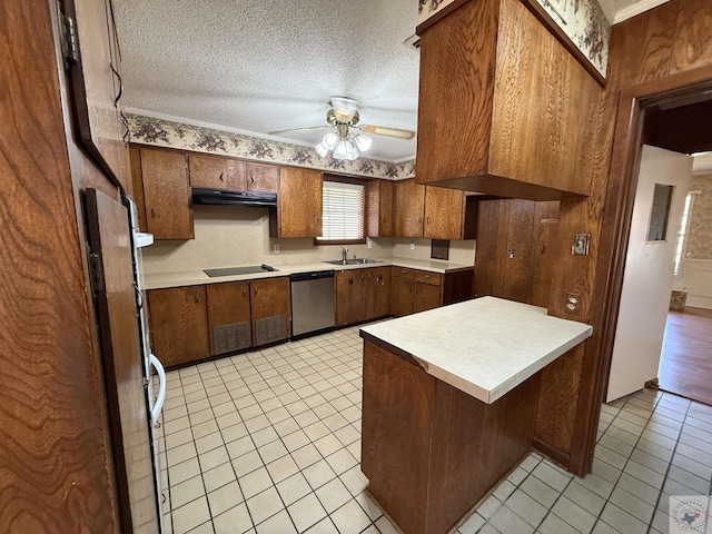 kitchen with kitchen peninsula, stainless steel dishwasher, ceiling fan, sink, and a textured ceiling