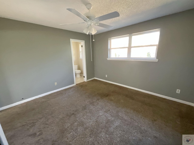 carpeted spare room with ceiling fan and a textured ceiling