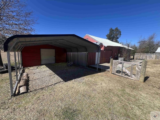 view of home's exterior with a garage, an outdoor structure, and a carport