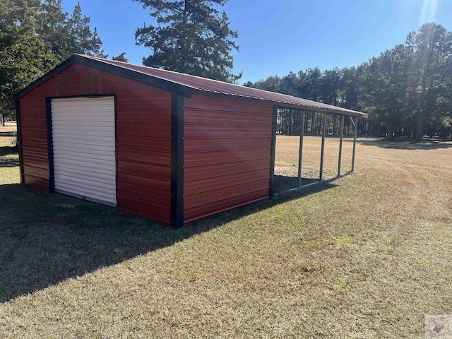 view of outdoor structure with a yard and a garage