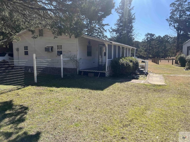 view of side of property with a yard