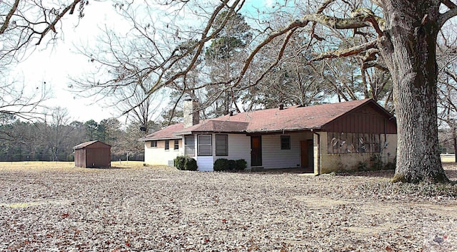 view of front of house featuring a storage shed