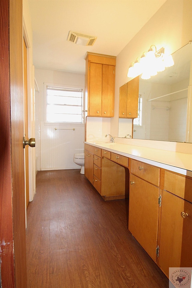 bathroom featuring hardwood / wood-style floors, toilet, and a healthy amount of sunlight