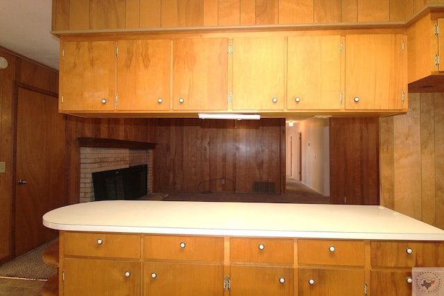 kitchen with wood walls and a fireplace