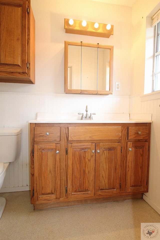 bathroom featuring toilet and vanity