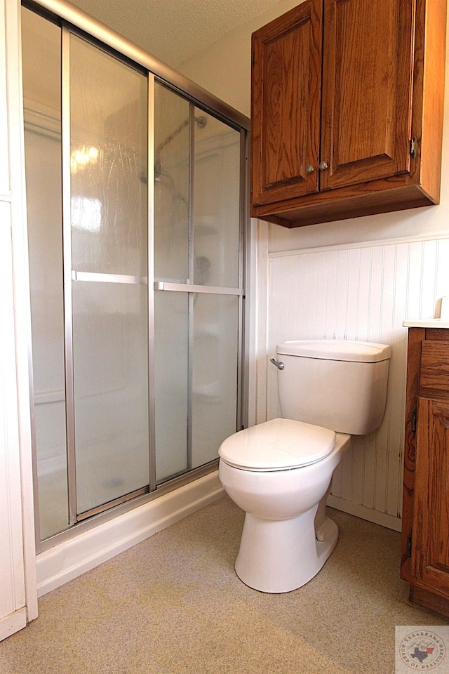 bathroom featuring toilet and walk in shower