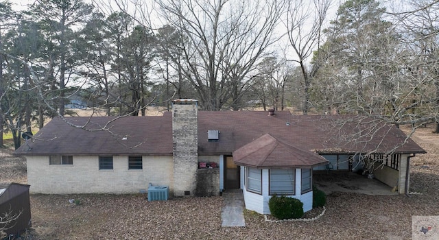 rear view of property featuring central AC