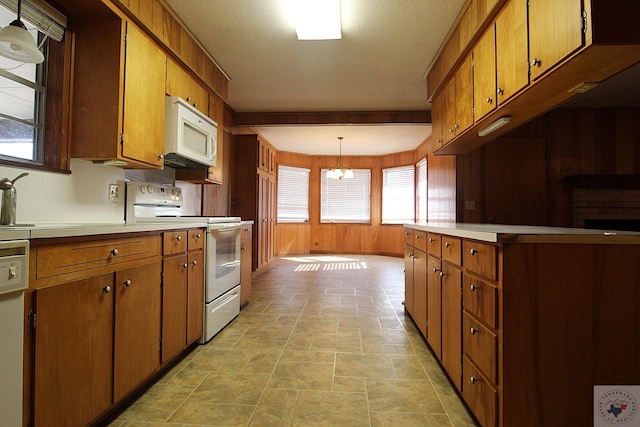 kitchen with a chandelier, white appliances, and hanging light fixtures