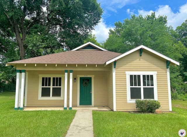 2124 Stevenson St, Texarkana, TX 75501 - bungalow with a front lawn, a shingled roof, and a porch