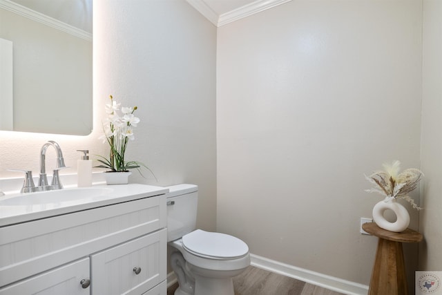 bathroom with wood-type flooring, toilet, vanity, and ornamental molding