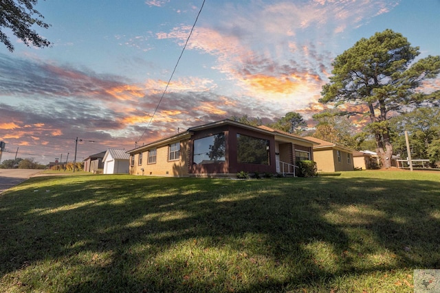 property exterior at dusk featuring a yard