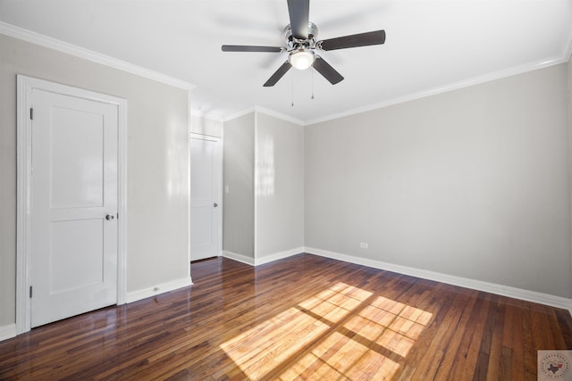 spare room featuring dark wood-type flooring, ceiling fan, and ornamental molding