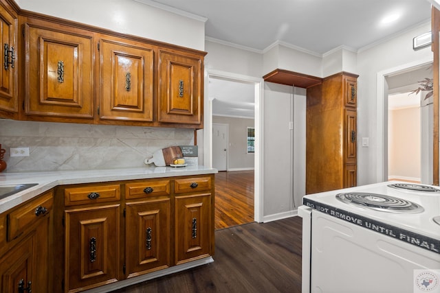 kitchen featuring white range with electric stovetop, crown molding, dark wood-type flooring, and backsplash