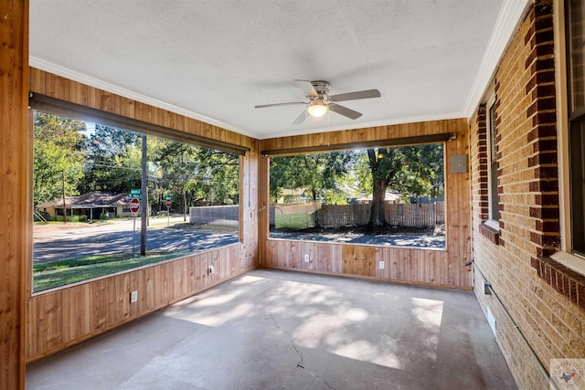 unfurnished sunroom featuring a healthy amount of sunlight and ceiling fan