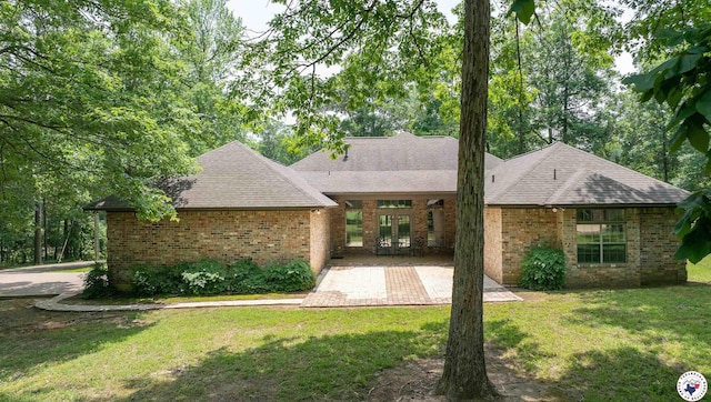 1305 Centerhill Rd, Linden, TX 75563 - view of front of house with french doors, brick siding, a front yard, and roof with shingles