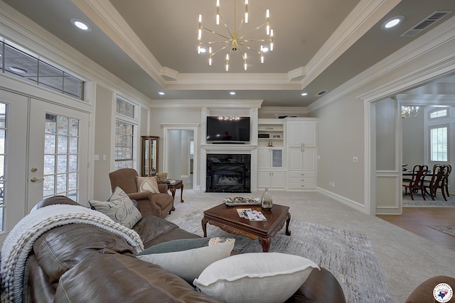 1305 Centerhill Rd, Linden, TX 75563 - living room with light carpet, a chandelier, a raised ceiling, a high end fireplace, and crown molding