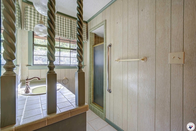 full bathroom featuring wood walls, a shower stall, a washtub, and tile patterned flooring