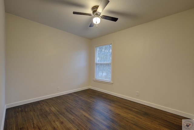 empty room with ceiling fan and dark hardwood / wood-style flooring