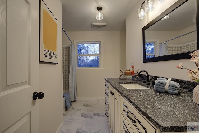 bathroom featuring vanity and shower / bath combo