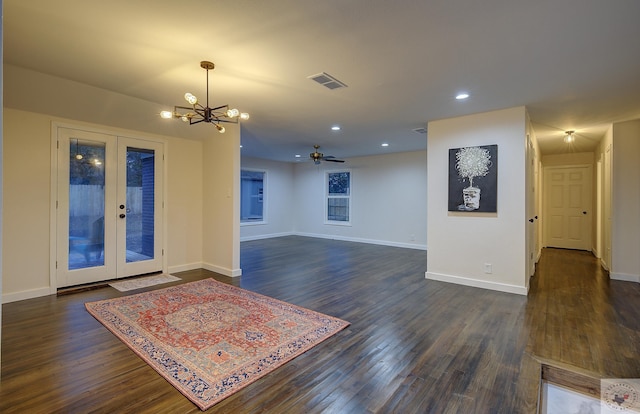 spare room featuring french doors, dark hardwood / wood-style flooring, and ceiling fan with notable chandelier