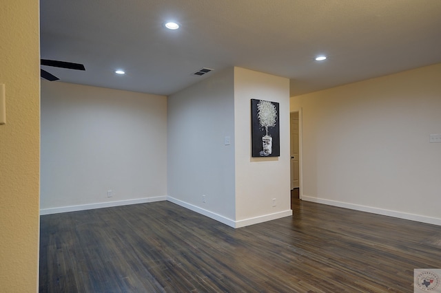 empty room featuring dark hardwood / wood-style flooring and ceiling fan