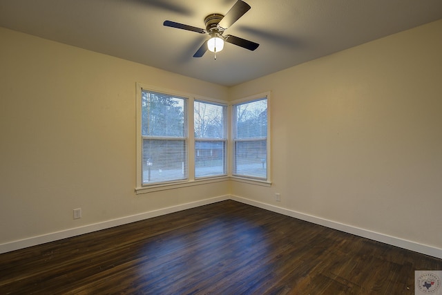 spare room with ceiling fan and dark hardwood / wood-style floors